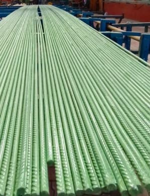 Epoxy-coated TMT bars prepared for construction reinforcement.