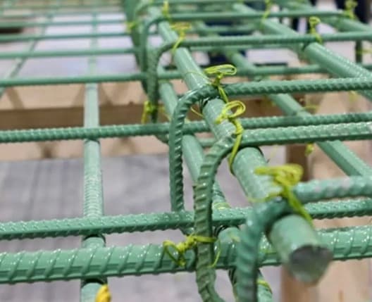 Epoxy-coated TMT bars prepared for construction reinforcement.